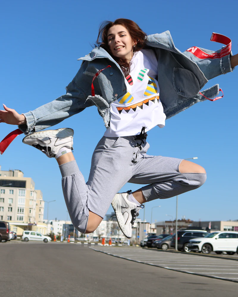 Energetic business owner leaping for joy in the city after fast business funding