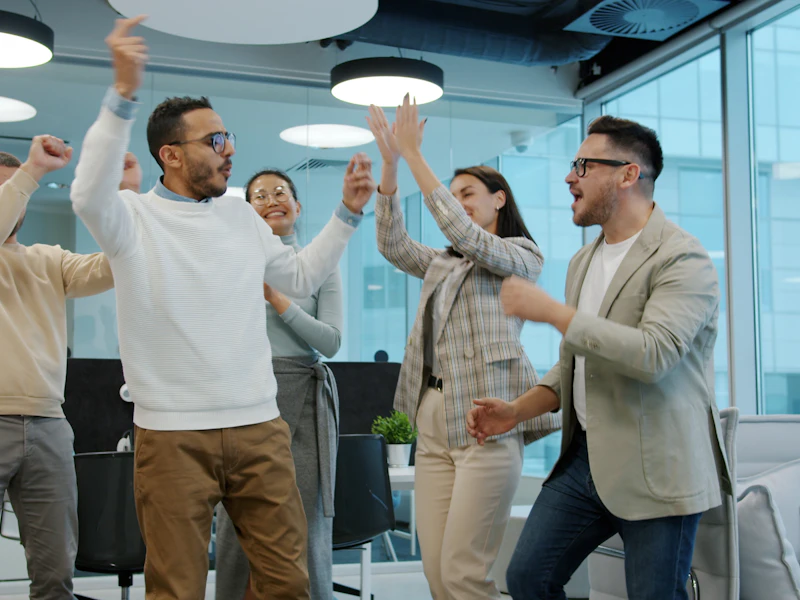 Small business team celebrating together in the office