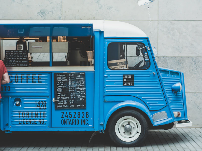 Blue vintage delivery van parked on the street